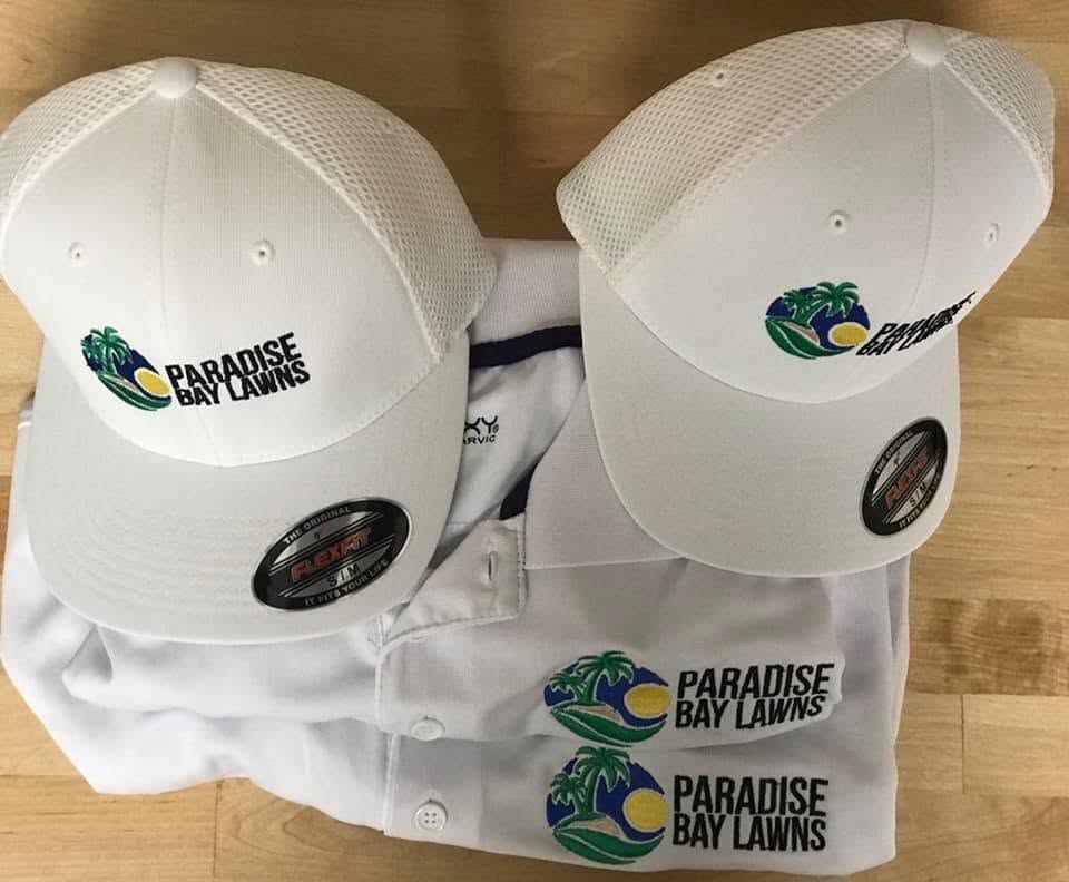 Custom embroidered Flexfit hats and polos for Paradise Bay Lawns